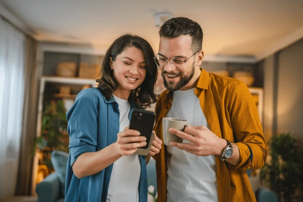 Couple using a home phone