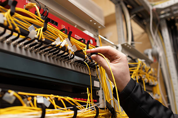 Technician installing networking equipment